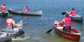 Troop members canoeing at summer camp